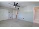 Bright bedroom with neutral walls, plush carpet, double closets, and an en suite bathroom at 6844 S Broadway, Littleton, CO 80122
