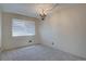 Empty bedroom featuring neutral walls, plush carpet, and a horizontal-blinded window at 6844 S Broadway, Littleton, CO 80122