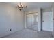 Bright bedroom featuring mirrored closet doors, neutral walls, and plush carpet at 6844 S Broadway, Littleton, CO 80122