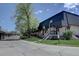 Exterior view of a townhome with a well-maintained lawn and nearby garages at 6844 S Broadway, Littleton, CO 80122