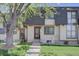 Charming townhome featuring a landscaped front yard and classic architectural details at 6844 S Broadway, Littleton, CO 80122