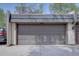 Attached two-car garage with concrete driveway at 6844 S Broadway, Littleton, CO 80122