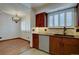 Kitchen area with stainless steel appliances and ample cabinet space, flowing into dining area at 6844 S Broadway, Littleton, CO 80122