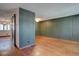 An empty living room with hardwood floors and stylish interior design at 6844 S Broadway, Littleton, CO 80122