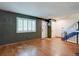 A bright living room featuring hardwood floors, a window with shutters, and fresh paint at 6844 S Broadway, Littleton, CO 80122