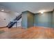 Living room with hardwood floors and a staircase leading to the upper level at 6844 S Broadway, Littleton, CO 80122
