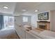 Bright living room with a fireplace, sliding glass doors, and comfortable neutral furniture at 6844 S Broadway, Littleton, CO 80122