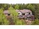 Aerial view of the home with a multi-level deck and surrounding trees at 11094 Thomas Dr, Conifer, CO 80433