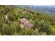 Secluded home surrounded by lush forest, offering privacy and tranquility at 11094 Thomas Dr, Conifer, CO 80433