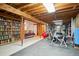 Partially finished basement that has a bedroom, gym and a bookshelf at 11094 Thomas Dr, Conifer, CO 80433