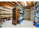 Unfinished basement with lots of storage space, shelving and a wine rack at 11094 Thomas Dr, Conifer, CO 80433