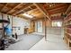 Unfinished basement with workout equipment and a separate storage area at 11094 Thomas Dr, Conifer, CO 80433