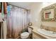 Bathroom showcasing decorative shower curtain, accent mirror, and neutral colored counter and sink at 11094 Thomas Dr, Conifer, CO 80433