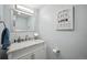 Bathroom features updated lighting and vanity with storage at 11094 Thomas Dr, Conifer, CO 80433