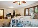Spacious bedroom with a large bed, closet, and natural light through large windows at 11094 Thomas Dr, Conifer, CO 80433