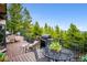 Outdoor deck with comfortable seating and a barbecue grill, perfect for enjoying the outdoors at 11094 Thomas Dr, Conifer, CO 80433