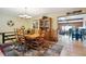 Elegant dining room featuring hardwood floors, a wooden table and chairs, and a decorative hutch at 11094 Thomas Dr, Conifer, CO 80433
