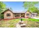 Charming home exterior featuring a well-maintained lawn and inviting front porch seating at 11094 Thomas Dr, Conifer, CO 80433