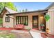 Inviting front porch with a swing, colorful plants, and a decorative welcome bear at 11094 Thomas Dr, Conifer, CO 80433