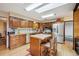 Well-equipped kitchen features wood cabinets, stainless steel appliances, and a central island at 11094 Thomas Dr, Conifer, CO 80433