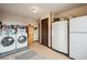 Spacious laundry room features tiled floor and modern washer and dryer units at 11094 Thomas Dr, Conifer, CO 80433