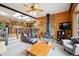 Open-concept living room with a wood-burning stove and an access to the kitchen at 11094 Thomas Dr, Conifer, CO 80433