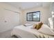 Cozy bedroom with sliding closet doors and window views at 1717 Grove St, Denver, CO 80204