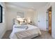 Bright bedroom with window, plush bed, and side table at 1717 Grove St, Denver, CO 80204
