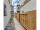 Back exterior of modern townhouse with wooden fence and walkway at 1717 Grove St, Denver, CO 80204