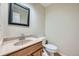 Well-maintained bathroom with a single sink vanity, a large mirror, and a standard toilet at 3334 Navajo St, Denver, CO 80211