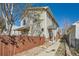 Well-kept home with vinyl siding, a walkway leading to the entrance, and a secure fenced yard at 3334 Navajo St, Denver, CO 80211