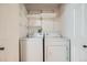 Cozy laundry room featuring a full-size washer and dryer, with wire shelving for extra storage space at 3334 Navajo St, Denver, CO 80211