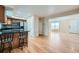 Open-concept living space featuring hardwood floors, natural light, and seamless flow from kitchen to living area at 3334 Navajo St, Denver, CO 80211
