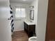 Modern bathroom with a stylish vanity, updated fixtures, and natural light at 1530 Whippoorwill Dr, Lakewood, CO 80215