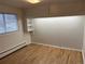 Cozy bedroom with built-in storage and hardwood flooring at 1530 Whippoorwill Dr, Lakewood, CO 80215