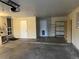 Spacious garage featuring shelving, and multiple entry doors for easy access and storage at 1530 Whippoorwill Dr, Lakewood, CO 80215