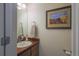 Compact half-bathroom featuring a sink, vanity, and neutral decor at 3754 Broadview Pl, Castle Rock, CO 80109