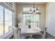 Bright breakfast nook features a garden view from large windows and a white table with upholstered chairs at 3754 Broadview Pl, Castle Rock, CO 80109