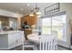 An eat-in kitchen boasts wood cabinets, modern appliances, and a bright window view at 3754 Broadview Pl, Castle Rock, CO 80109