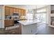 Well-lit kitchen with a center island, stainless steel appliances, and a sliding glass door at 3754 Broadview Pl, Castle Rock, CO 80109