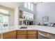 Open kitchen area with bright white counter tops and a view into the living room and backyard at 3754 Broadview Pl, Castle Rock, CO 80109