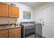 Functional laundry room with modern washer/dryer, utility sink, ample storage, and convenient access to the door at 3754 Broadview Pl, Castle Rock, CO 80109