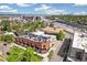 Aerial view showcasing a modern brick apartment building with rooftop decks and convenient highway access at 485 E Arizona Ave, Denver, CO 80210