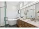 Beautiful bathroom featuring double sinks, a soaking tub, and modern fixtures for a spa-like experience at 485 E Arizona Ave, Denver, CO 80210