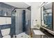 Bathroom features a modern glass shower, with gray brick tile and a sleek vanity at 485 E Arizona Ave, Denver, CO 80210