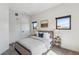 Comfortable bedroom with neutral decor, plush bedding, and natural light, ideal for relaxation at 485 E Arizona Ave, Denver, CO 80210