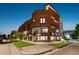 Modern brick building with large windows, corner lot, and well-manicured landscaping on a peaceful, residential street at 485 E Arizona Ave, Denver, CO 80210