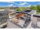 Rooftop patio featuring modern furniture, outdoor dining, and city views on a sunny day at 485 E Arizona Ave, Denver, CO 80210