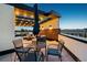 Charming rooftop deck with an outdoor dining set, comfortable lounge furniture, and stylish string lights at 485 E Arizona Ave, Denver, CO 80210