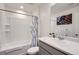 Clean bathroom with a shower-tub combo, framed mirror, and gray vanity at 7022 Todd Ct, Frederick, CO 80530
